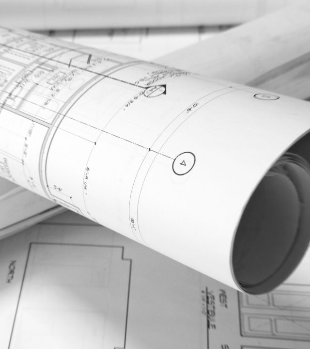 plans roled -up plans on the table